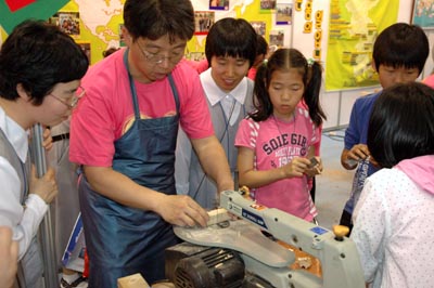 Kwangju, Korea  31 maggio 2008  Il sig. Alexander Cho, salesiano coadiutore, mostra uno dei programmi di falegnameria dei laboratori salesiani ad alcuni giovani e Figlie di Maria Ausiliatrice durante la Quarta Fiera Nazionale dei Giovani.