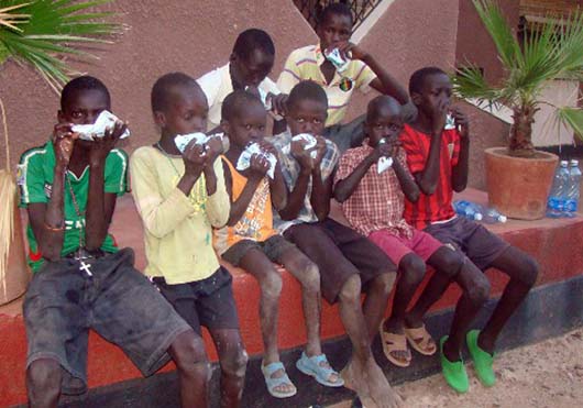 novembre 2013 – Missionari salesiani distribuiscono il latte ai bambini del campo profughi di Kakuma.